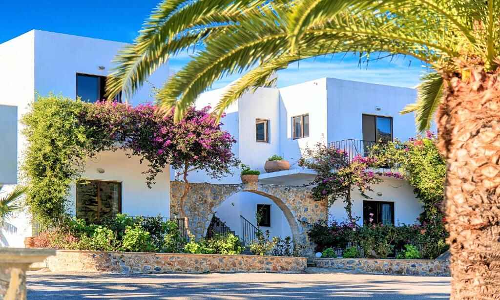 White Cretan buildings and bougainvillea at Welcome Apts
