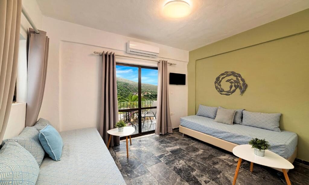 Living area with balcony view at Welcome Apts